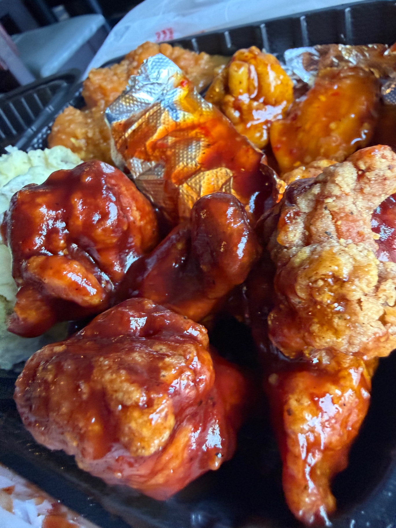 Fried chicken wings tossed in glossy BBQ sauce