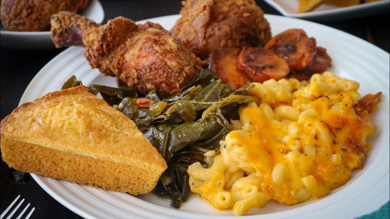 Soul food plate with fried chicken, mac and cheese, collard greens, yams and cornbread